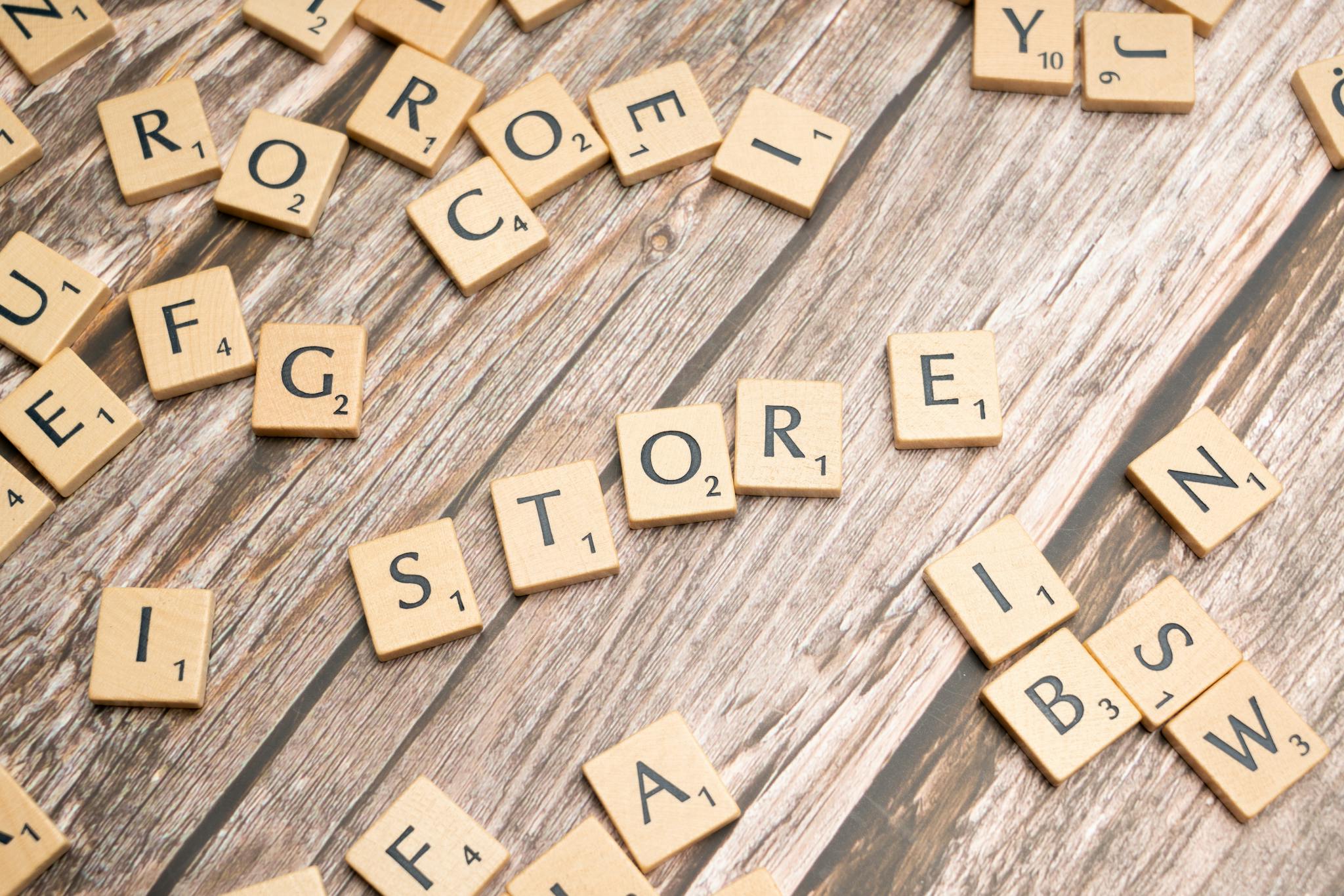 Scrabble tiles forming the word 'store' on a wooden surface, ideal for retail or typography themes.